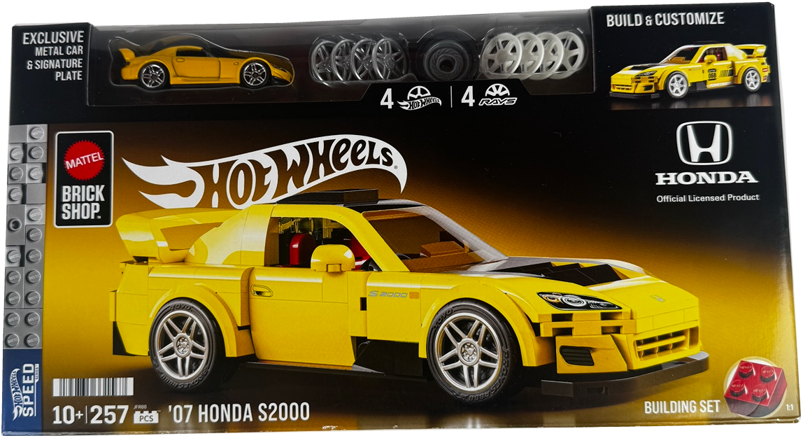 Hot Wheels Brick Shop Mattel official licensed product packaging for the 2007 Honda S2000 building set. The box features a large yellow assembled model car on a black and yellow background, with a clear window at the top showing included metal car and signature rim pieces, and branding for Mattel, Hot Wheels, and Honda.