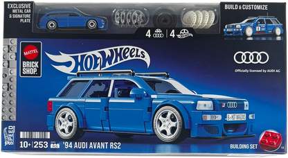 Box packaging for a Hot Wheels Brick Shop building set featuring a blue 1994 Audi Avant RS2 model car. The front of the box shows the assembled blue car, the Hot Wheels logo, the Mattel Brick Shop logo, an Audi logo, and a small preview of included metal car parts at the top.