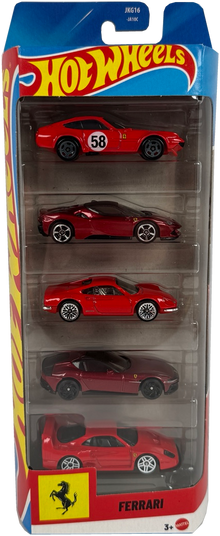 A Hot Wheels toy car set in retail packaging, featuring five miniature Ferrari sports cars in red and dark metallic shades, displayed in a clear plastic blister pack with a blue and red Hot Wheels header card.