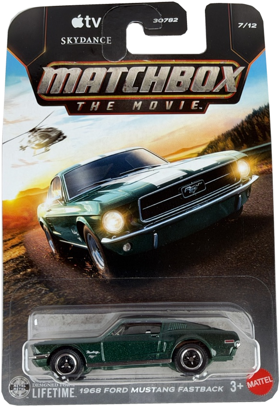 Matchbox The Movie 2018 Ford Mustang Fastback diecast toy car in a green finish, packaged on its original cardback featuring a printed image of the car on a sunset road scene.
