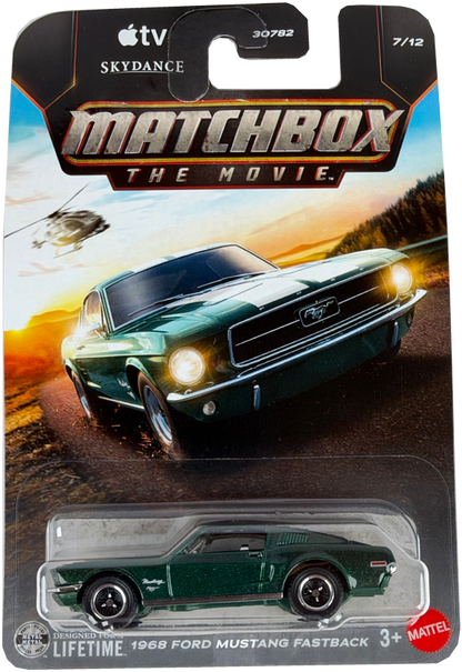 Matchbox The Movie 2018 Ford Mustang Fastback diecast toy car in a green finish, packaged on its original cardback featuring a printed image of the car on a sunset road scene.