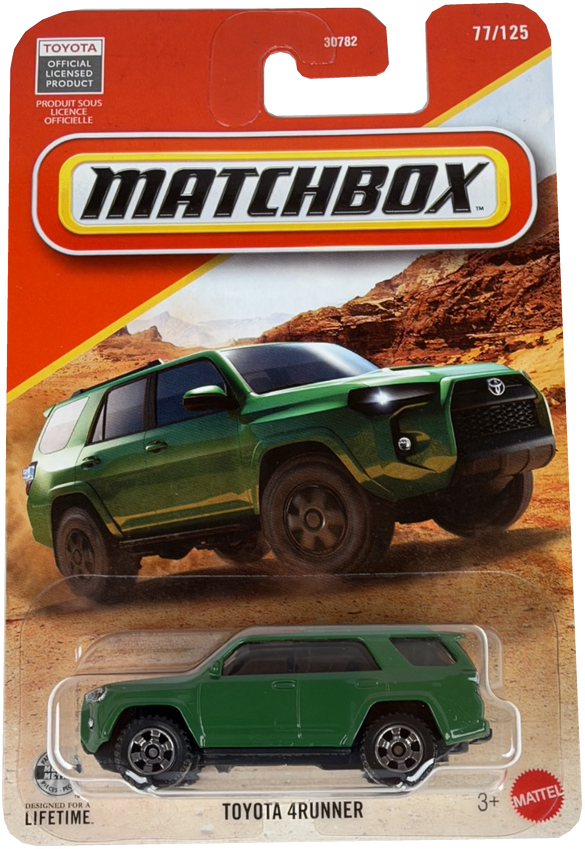 Matchbox Toyota 4Runner diecast toy car in green, displayed on its original orange and white blister card packaging with a desert landscape background.