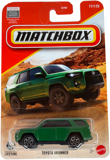 Matchbox Toyota 4Runner diecast toy car in green, displayed on its original orange and white blister card packaging with a desert landscape background.