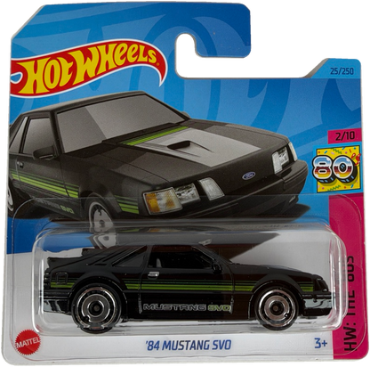 Hot Wheels '84 Mustang SVO diecast toy car in its original blister packaging, featuring a black car with green and white stripes on a blue and white card.