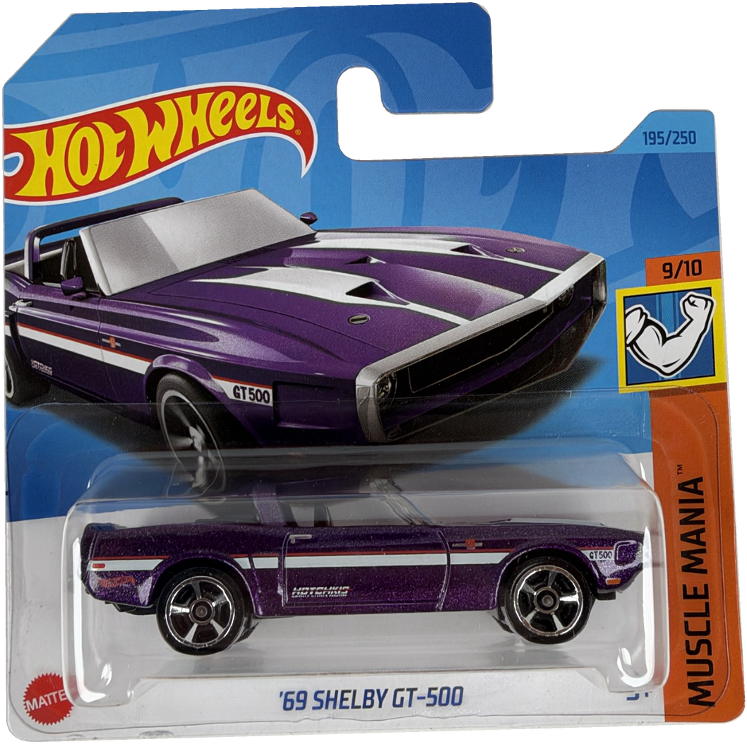 Hot Wheels Muscle Mania '69 Shelby GT-500 die-cast toy car in its original blister packaging, featuring a purple car with white racing stripes.