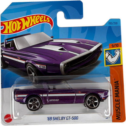 Hot Wheels Muscle Mania '69 Shelby GT-500 die-cast toy car in its original blister packaging, featuring a purple car with white racing stripes.